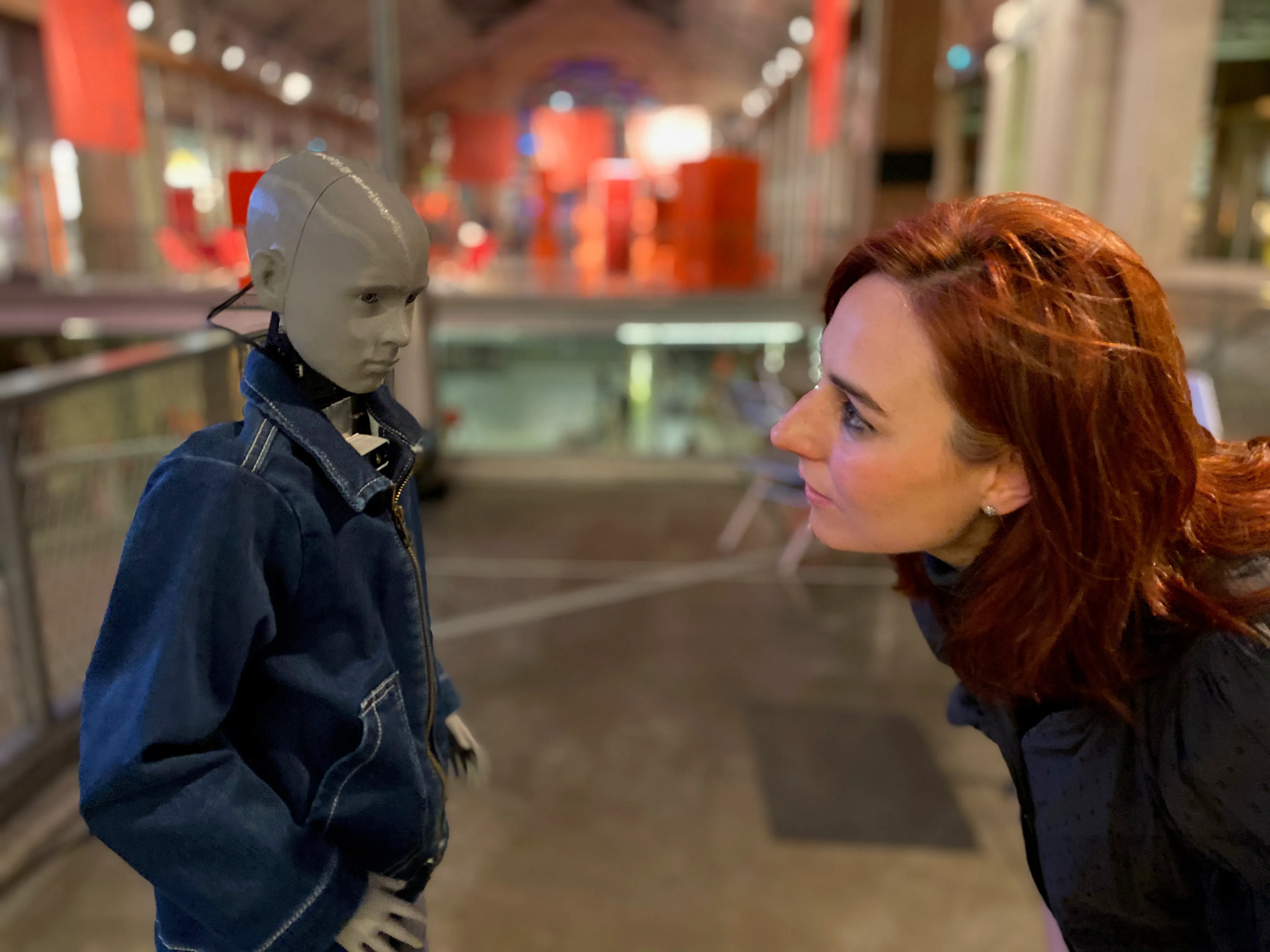 Cyberspecies Proximity installed at CENTQUATRE in Paris, showing the small humanoid robot moving through the exhibition space.