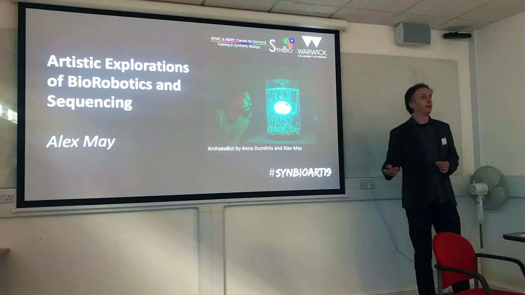 Promotional image for Alex May's SynBio19 talk on biorobotics and sequencing.