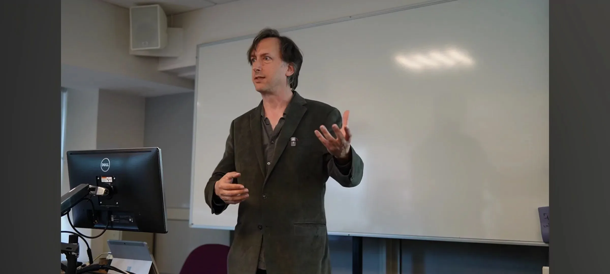 Alex May speaking during The Cabinet of Intangible Curiosities artist talk at the University of Surrey.