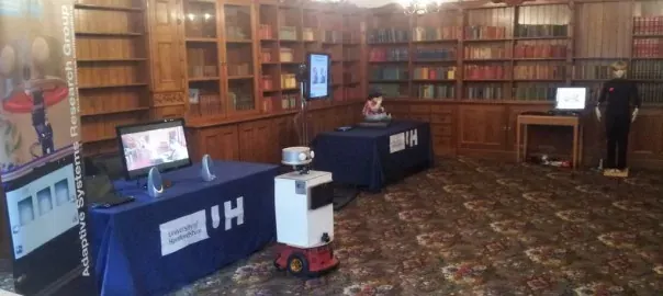 Robots and screens installed in the Bletchley Park mansion library during the My New Robot Companion event