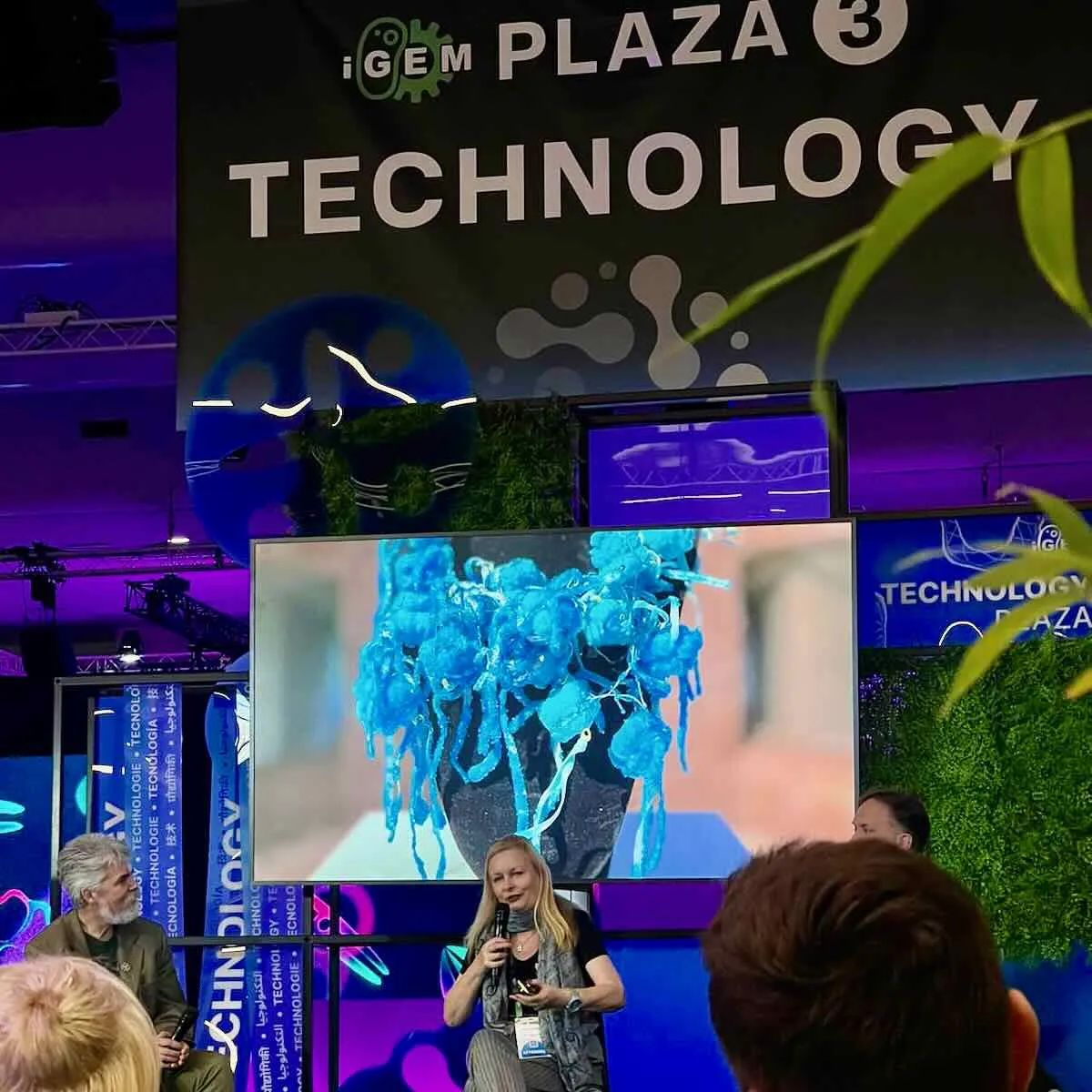 Anna Dumitriu speaking at Technology Plaza 3 during iGEM Jamboree 2024 in Paris Expo